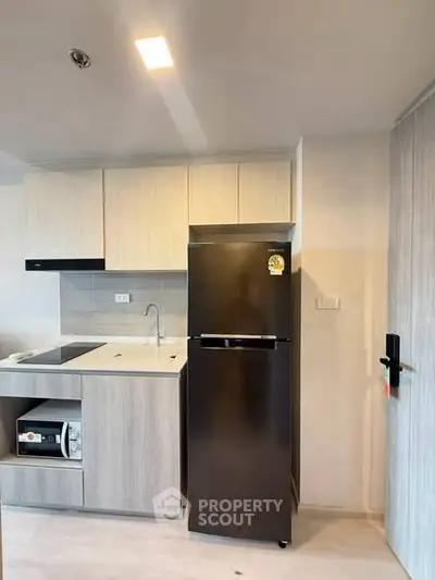 Modern kitchen with sleek appliances and minimalist design in a contemporary apartment.