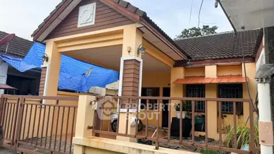Charming single-story home with a gated entrance and covered porch, ideal for cozy living.