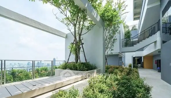 Modern apartment building with lush greenery and city view