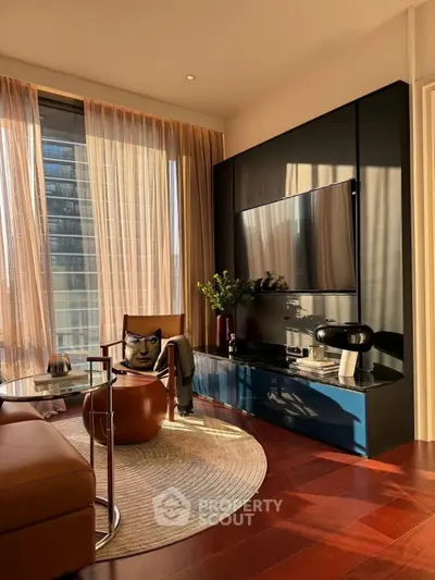 Stylish living room with modern decor, large TV, and floor-to-ceiling windows offering natural light.