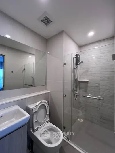 Modern bathroom with sleek shower and contemporary fixtures in a stylish apartment.