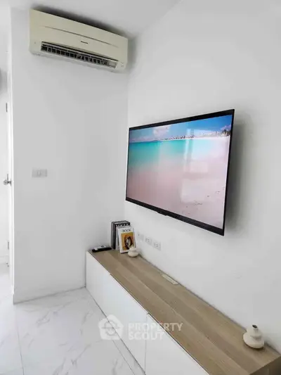 Modern living room with wall-mounted TV and air conditioning unit