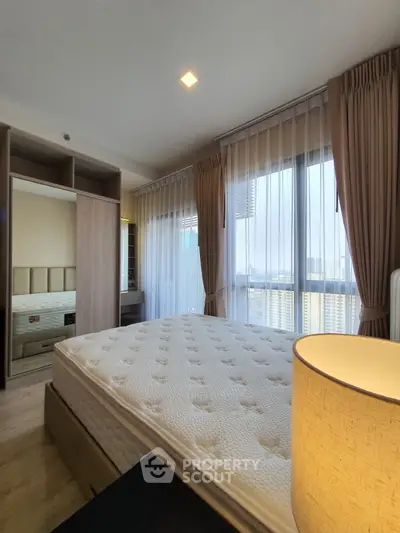 Bright and airy bedroom with large windows and modern furnishings