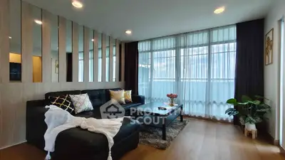 Spacious modern living room with elegant decor and large windows for natural light.
