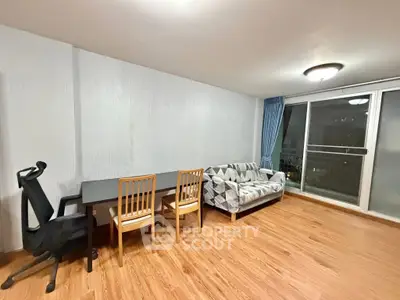 Spacious living room with modern furnishings and large window view.