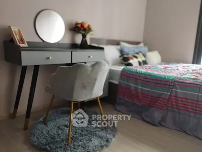 Chic bedroom with stylish vanity, cozy bed, and modern decor for a comfortable living space.