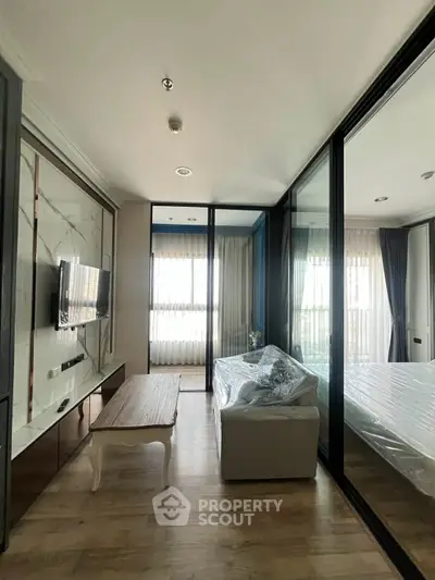 Modern living room with glass partition and natural light