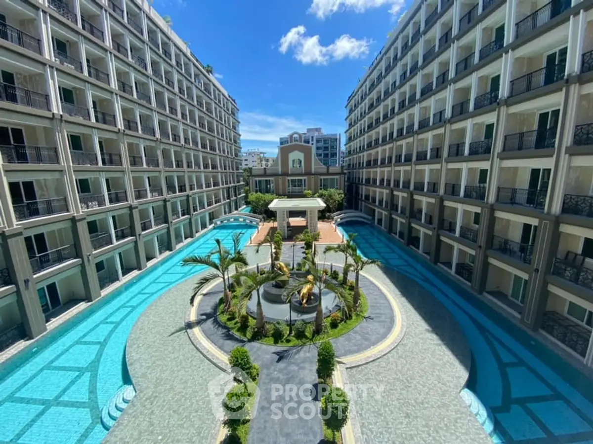 Luxurious apartment complex with stunning pool and landscaped courtyard view.
