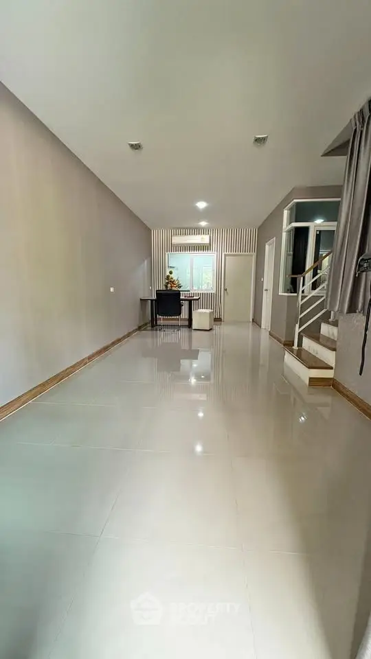 Spacious modern living room with sleek tile flooring and neutral decor