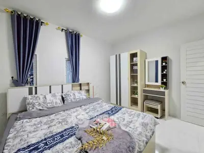 Cozy bedroom with modern decor, featuring a comfortable bed, stylish wardrobe, and elegant curtains.