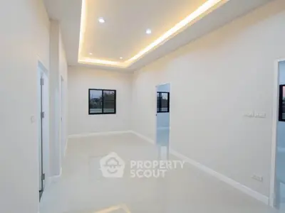 Spacious modern living room with recessed lighting and glossy tile flooring