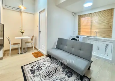 Charming compact living room with modern decor and cozy dining area, perfect for urban living.