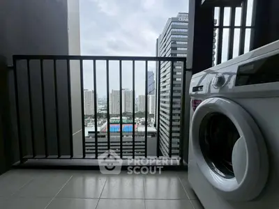 High-rise apartment balcony with city view and washing machine.