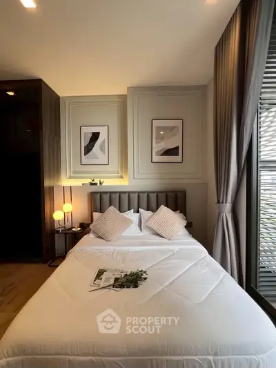 Elegant bedroom with modern decor, featuring a cozy bed, stylish artwork, and soft lighting for a serene ambiance.