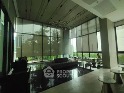 Luxurious modern lobby with high ceilings and stylish seating in a contemporary building.