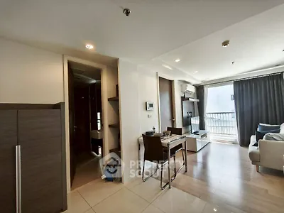 Modern living room with sleek furniture and balcony access in a stylish apartment.