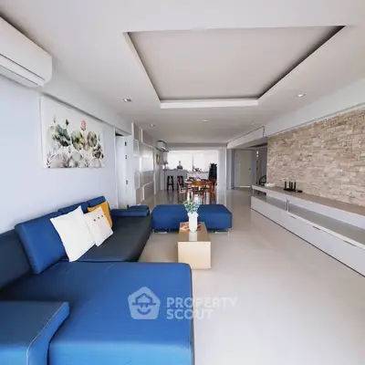 Spacious modern living room with blue sectional sofa and elegant decor