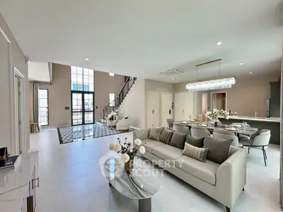Luxurious open-concept living room with elegant decor and high ceilings in modern home.