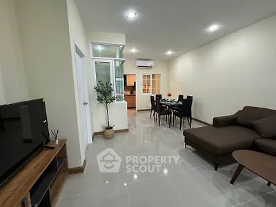 Spacious modern living room with sleek furniture and open layout, perfect for entertaining.