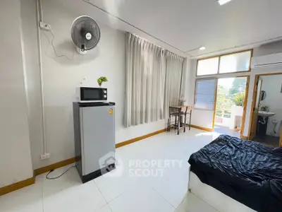 Spacious studio apartment with modern amenities and balcony view
