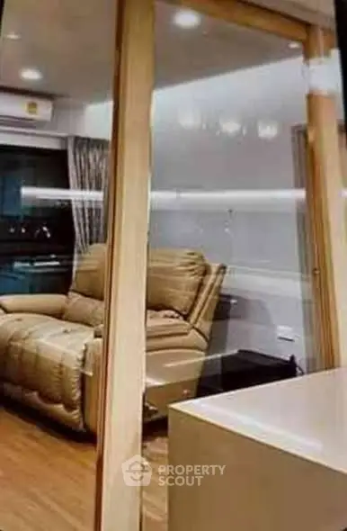 Modern living room with cozy recliner and sleek wooden flooring