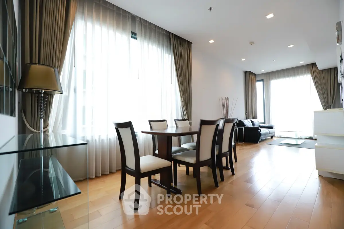 Spacious modern living room with elegant dining area and natural light