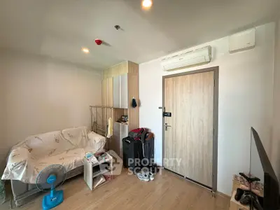 Cozy living room with modern air conditioning and stylish wooden door, perfect for urban living.
