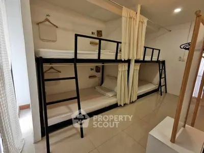 Modern hostel room with bunk beds and minimalist design