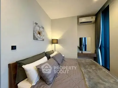 Modern bedroom with cozy bedding, stylish decor, and natural light for a serene living experience.