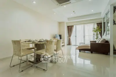 Spacious modern living room with dining area and large windows in a luxury apartment.
