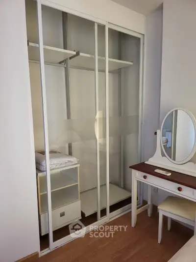 Spacious bedroom with elegant sliding wardrobe and vanity table