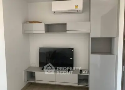 Modern living room with sleek TV unit and air conditioning, perfect for comfortable living.