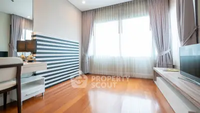 Spacious and bright living room with elegant decor and large windows