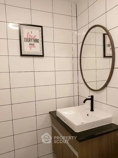 Modern bathroom with stylish mirror and sleek sink in contemporary design.