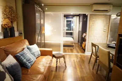 Stylish modern living room with leather sofa and wooden flooring
