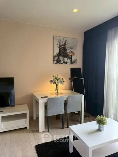 Modern living room with stylish decor and natural light, featuring a cozy dining area and elegant furnishings.