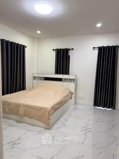 Spacious bedroom with modern design and elegant marble flooring