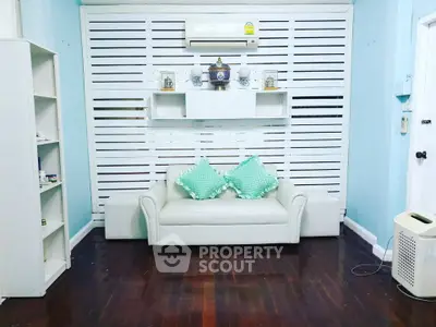 Charming living room with cozy white sofa and modern decor, perfect for relaxation.