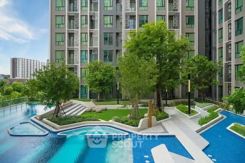 Modern apartment complex with lush garden and stylish pool area