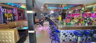 Vibrant bar interior with festive decorations and stylish seating, perfect for social gatherings.