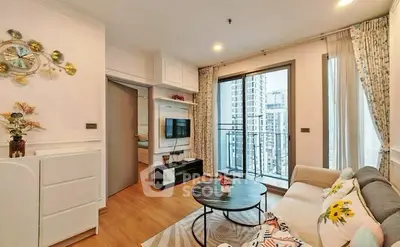 Modern living room with balcony view in high-rise apartment, featuring stylish decor and cozy seating area.