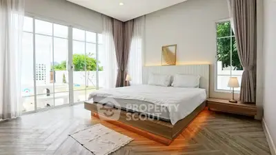 Modern bedroom with large windows and stylish lighting in a luxury home.