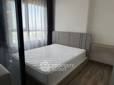 Modern bedroom with large window and stylish bed in a high-rise apartment