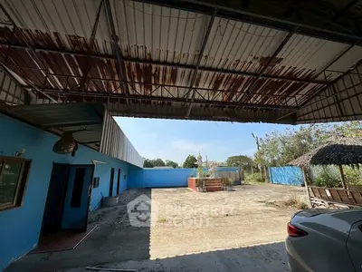 Spacious industrial property with open courtyard and partial roof cover, ideal for commercial use.