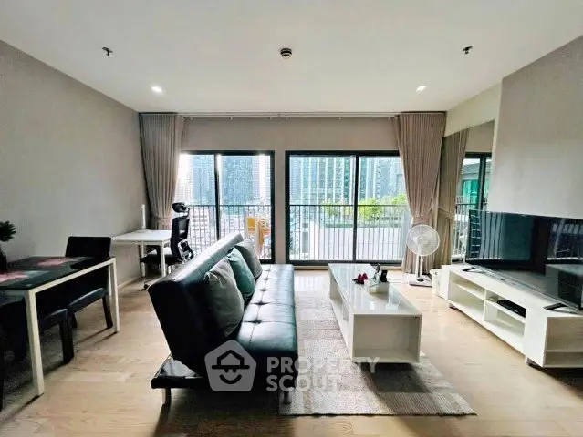 Spacious modern living room with city view, stylish furniture, and natural light.
