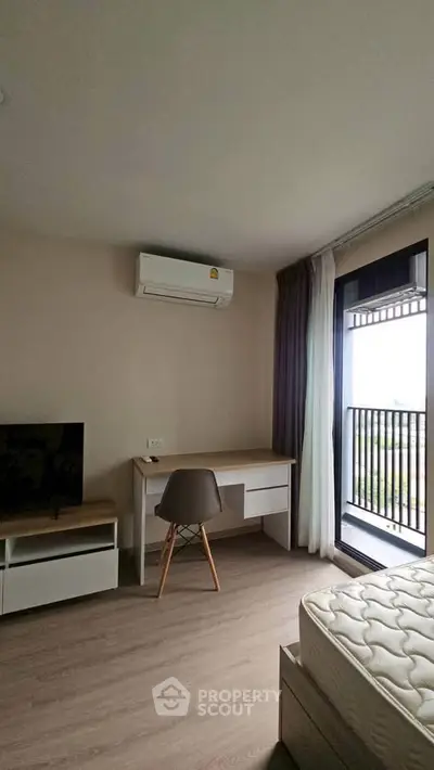 Modern bedroom with balcony access and sleek furniture design