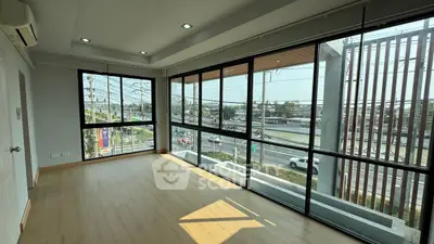 Spacious corner unit with large windows offering panoramic city views and abundant natural light.