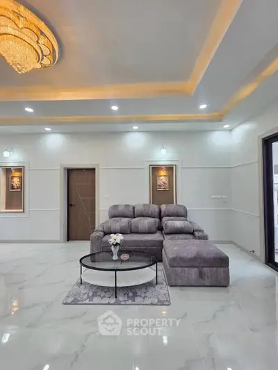 Luxurious modern living room with elegant lighting and plush gray sectional sofa.