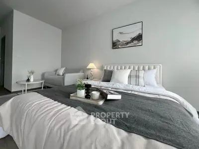 Modern bedroom with stylish decor and cozy ambiance, featuring a comfortable bed and elegant furnishings.