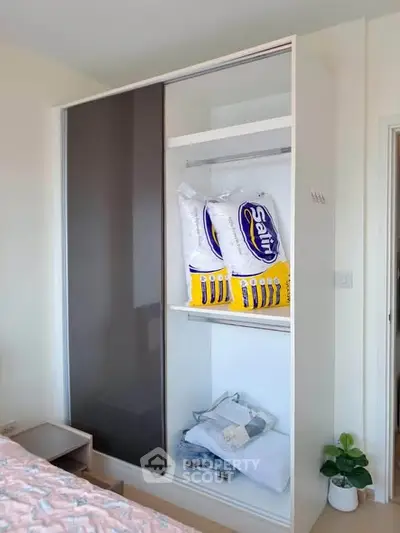 Spacious bedroom with modern sliding wardrobe and cozy decor